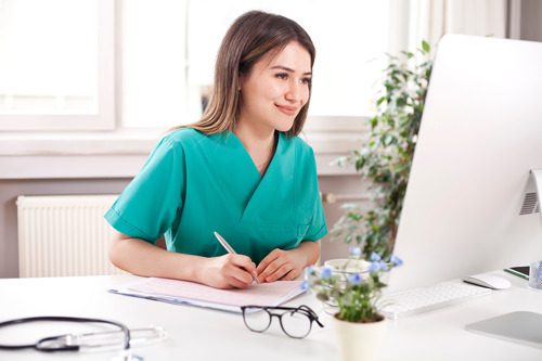 female-vet-working-at-computer-desk-in-office